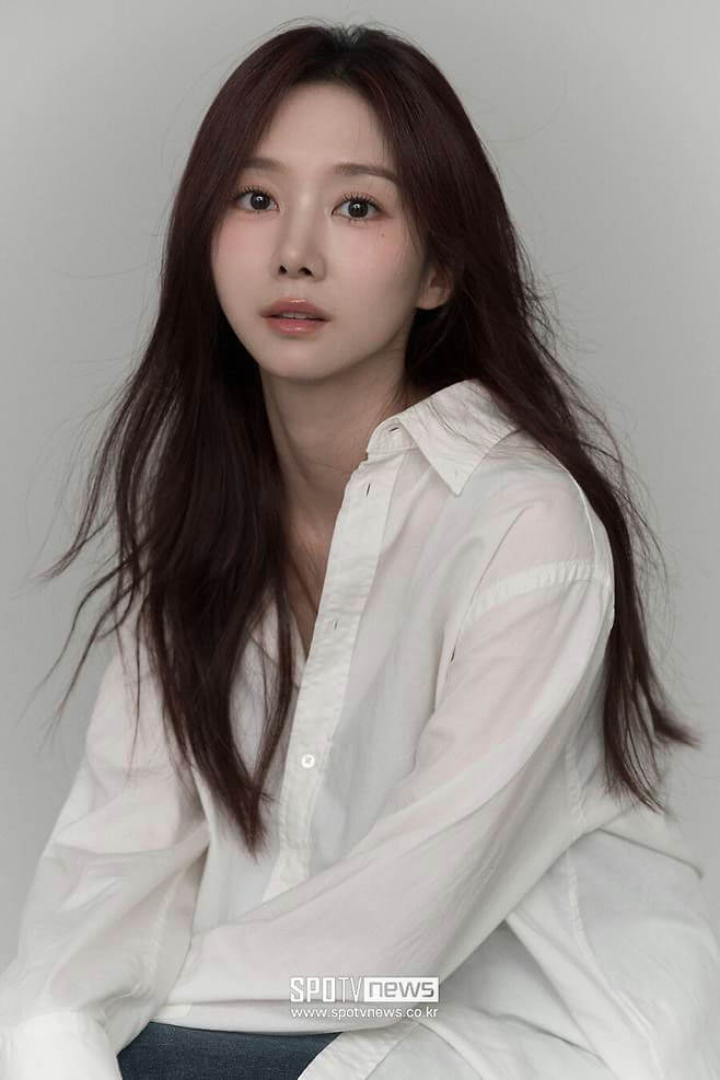 people-woman-A-long dark hair-A-white button-down shirt-A-headshot