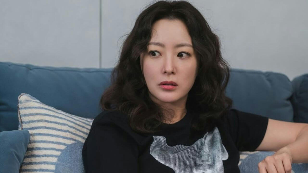 people-woman-A-dark wavy hair-A-surprised expression-A-black t-shirt-A-blue couch