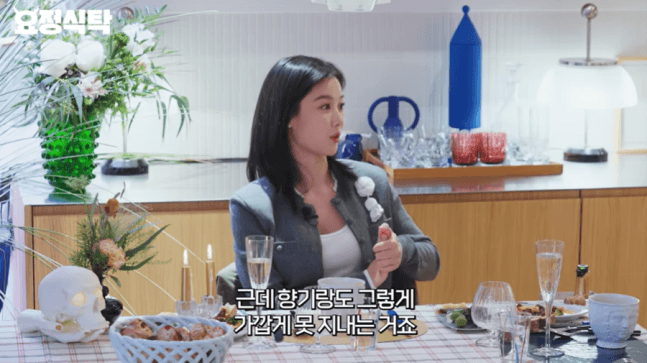 people-woman-dining-table-gray blazer-Korean subtitles-white top-decorative skull