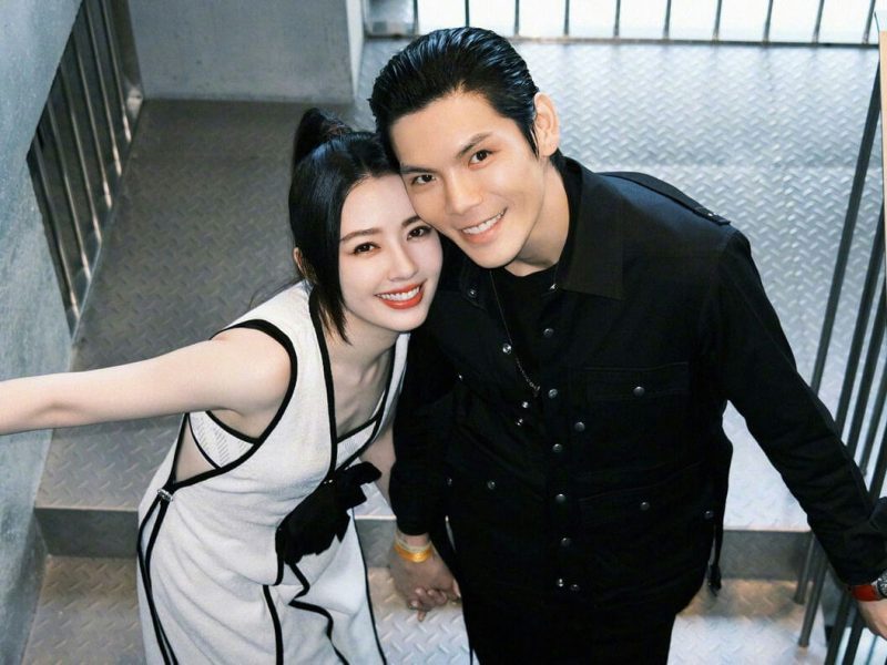 people-A-woman-A-man-A-couple-A-smiling-A-holding hands-A-black and white outfit-A-black shirt-A