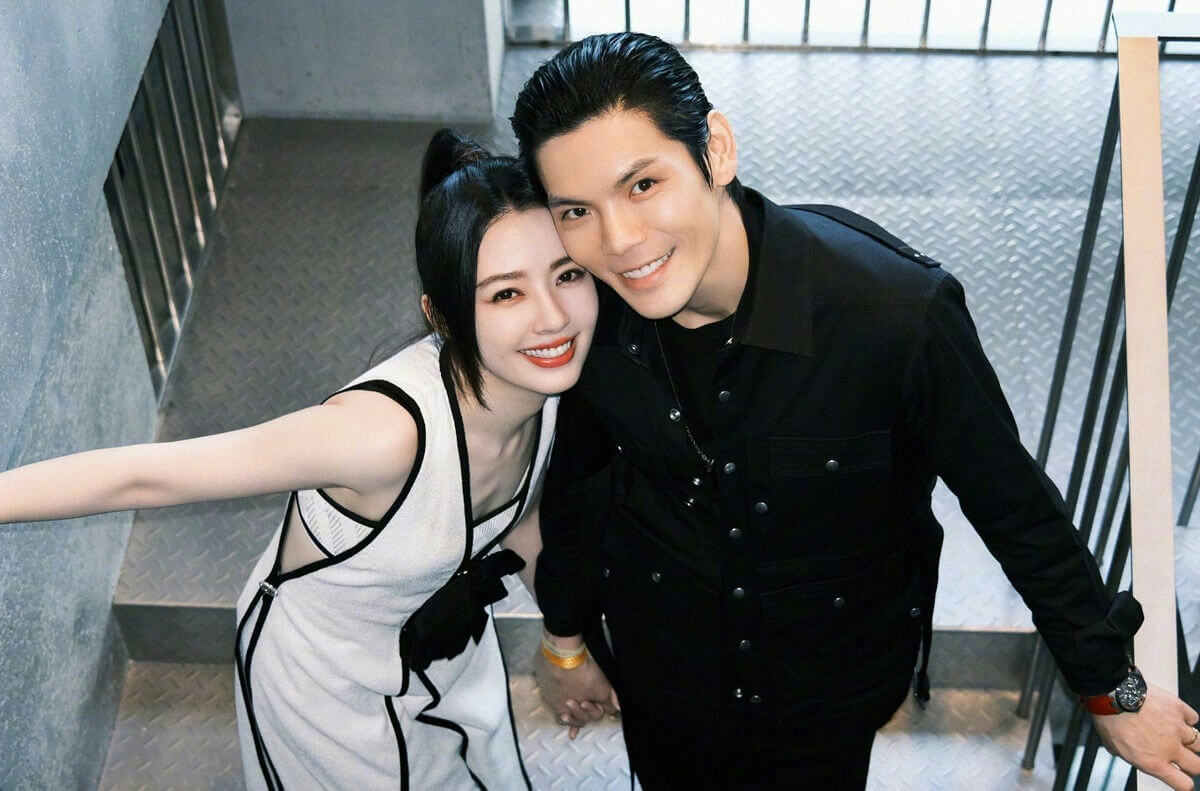 people-A-woman-A-man-A-couple-A-smiling-A-holding hands-A-black and white outfit-A-black shirt-A