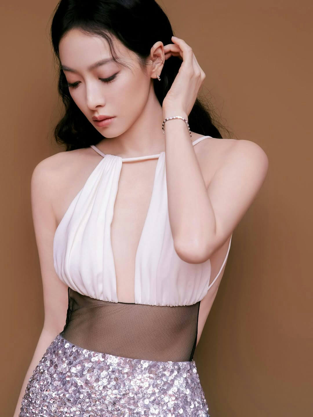people-Woman-A-White Halter Dress-A-Deep Plunging Neckline-B-Black Mesh Waistband-C-Silver Sequined Skirt