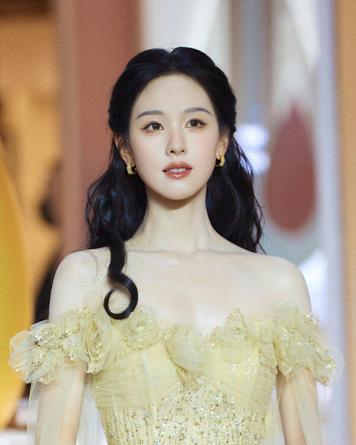 people-woman-Asian-woman-long dark hair-off-the-shoulder gown-yellow gown-gold accents-earrings