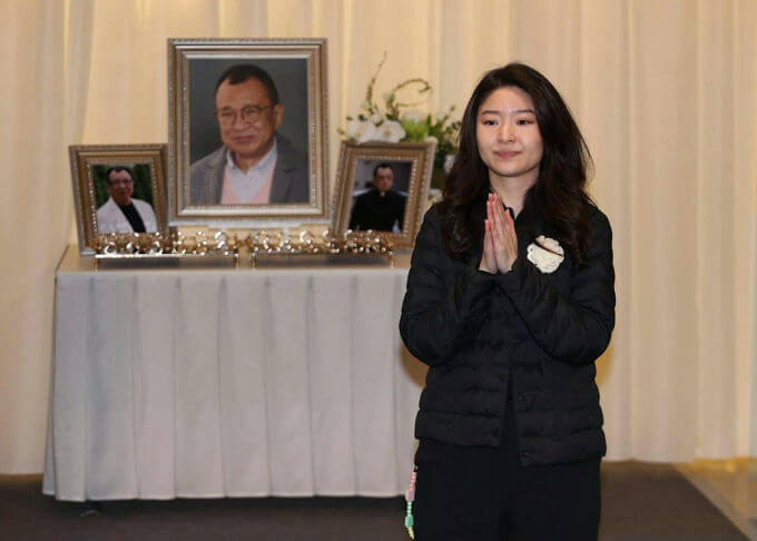 people-A-young-woman-A-grieving-A-hands-clasped-A-funeral-setting