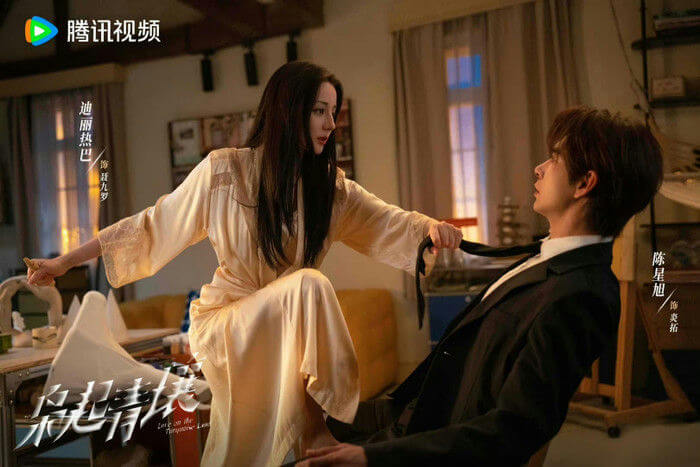 people-woman in a light-colored silky robe pulling a man's tie-man in a dark suit being pulled by the tie-intense gaze-dramatic lighting-poster for "Love on the Turquoise Land" (or similar Chinese drama title)