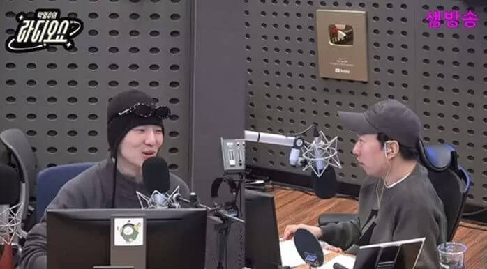 people-Two men-A-radio show-B-microphones-C-beanie and sunglasses