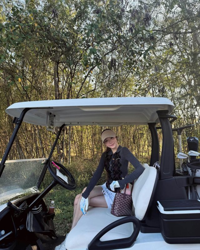 people-A-woman-A-golf-A-golf cart-A-woods