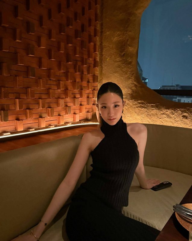 people-woman-A-black halter top-B-indoor restaurant setting-C-nighttime view