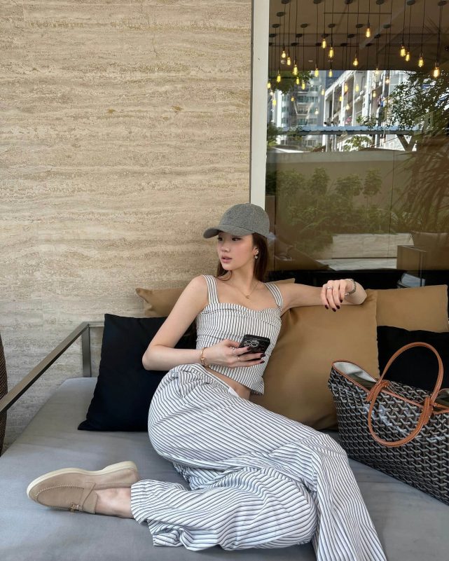 people-A-woman-A-striped-outfit-A-grey-cap-A-sitting