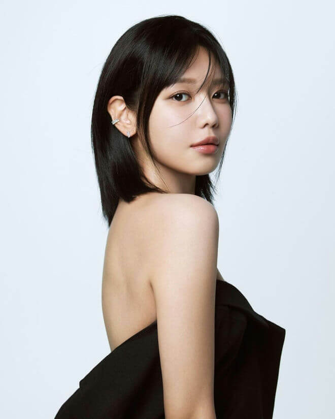 people-woman-A-short black hair-A-off-the-shoulder black top-B-ear cuff and small earring-C-glamour shot