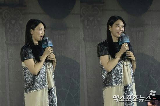 people-woman-speaking into a microphone-woman-long black hair-woman-sequined dress-woman-stage appearance