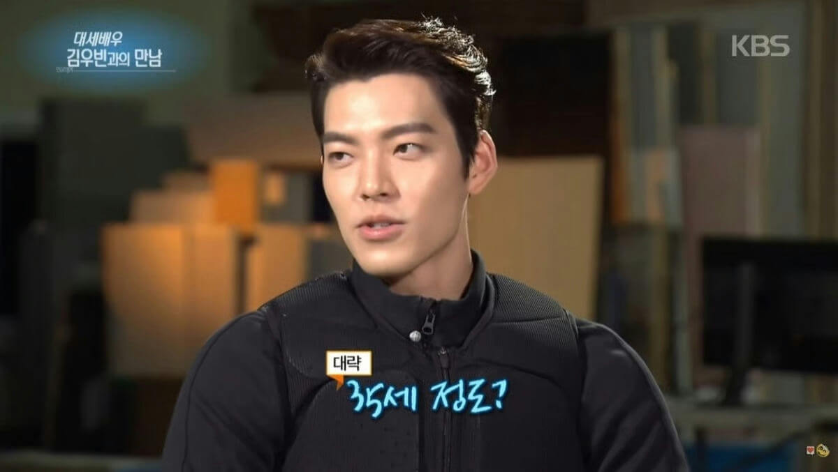 people-A-Kim Woo-bin-A-Korean actor-B-interview setting-C-Korean text overlays