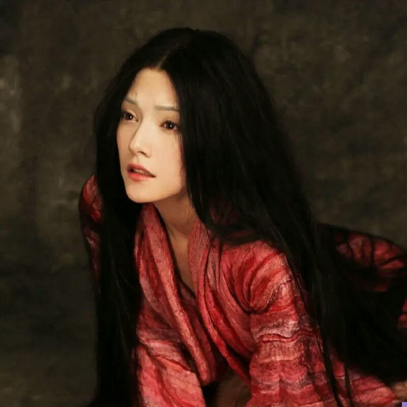 people-Woman-Long black hair-Red textured garment-Dramatic lighting
