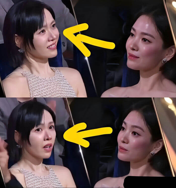 people-two East Asian women at an event-A-seated next to each other-A-one woman smiling at the other-B-the other woman looking forward or slightly to the side-C-yellow arrows indicating the direction of gaze or focus