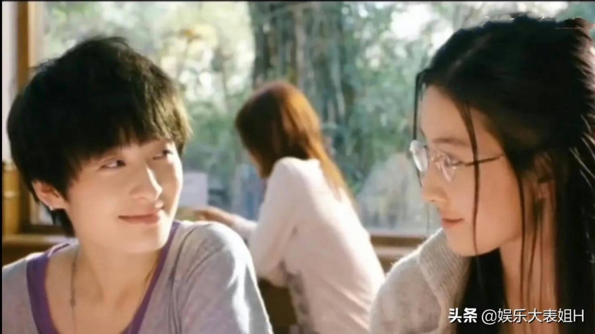people-two women and one person in the background-smiling-wearing glasses-short hair