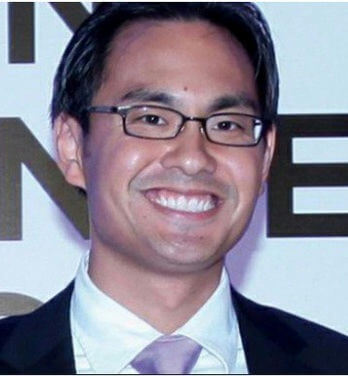 people-A-man-A-smiling-A-wearing glasses-A-wearing a suit