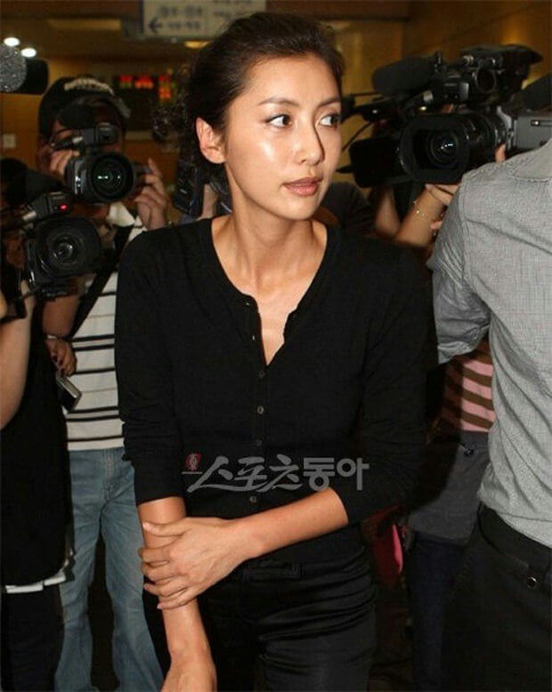 people-woman-A-black clothing-A-surrounded by cameras-A-looking away