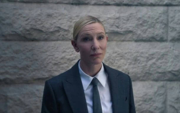 people-Cate Blanchett-A-suit-A-tie-A-blond hair-B-stone wall