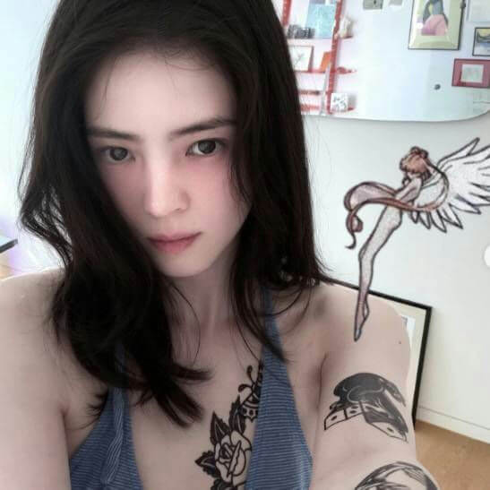 people-woman-A-dark hair-A-blue top-A-tattoos-B-drawing overlay