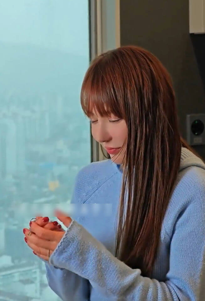 people-woman-A-long brown hair-B-light blue sweater-C-holding hands near window