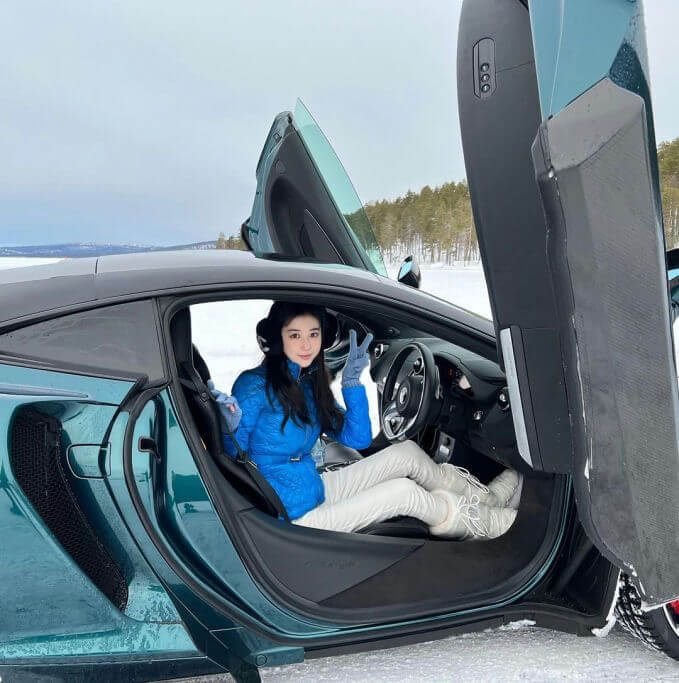 people-One woman-A-sitting in car-A-wearing blue jacket-A-giving peace sign-A-winter setting