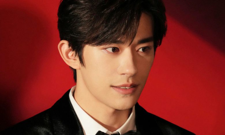 people-Man-Formal Attire-Formal Attire-Black Suit-Black Suit-White Shirt-White Shirt-Bow Tie-Bow Tie-Red Background-Red Background