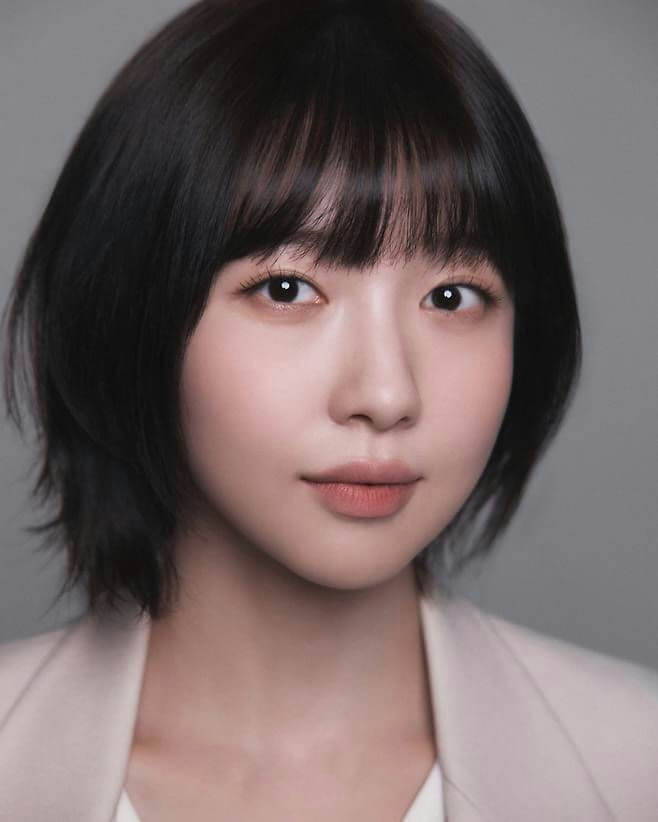 people-woman-short black hair-bangs-light skin-light makeup-blazer