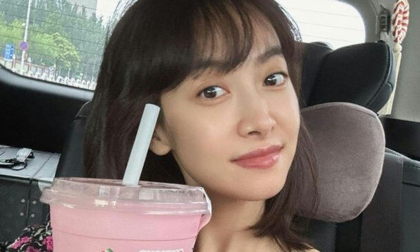 people-woman-A-holding-drink-A-sitting-in-car-A-smiling