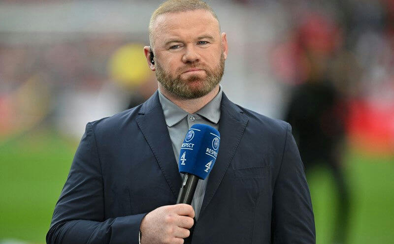people-Wayne Rooney-A-male-A-sports pundit-A-holding microphone-A-wearing suit