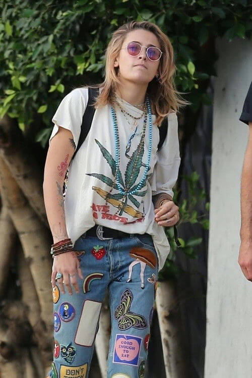 people-Paris Jackson-A-marijuana leaf graphic t-shirt-A-patchwork jeans-B-layered necklaces-C-sunglasses
