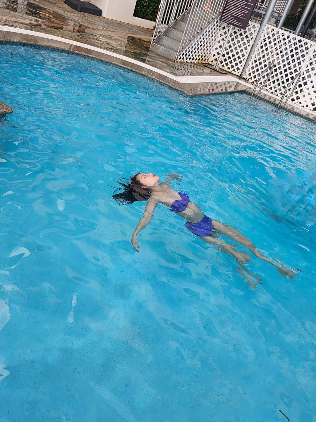 person-A-woman-A-floating-A-bikini-A-swimming-pool
