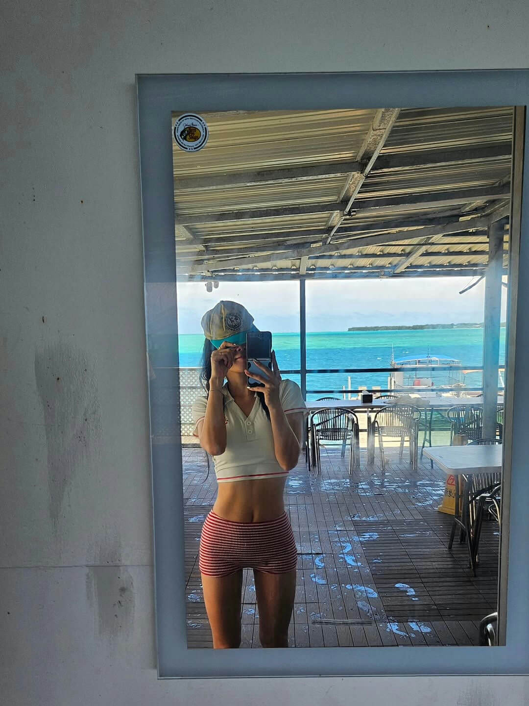 person-A-mirror selfie-A-crop top-B-striped shorts-C-tropical view