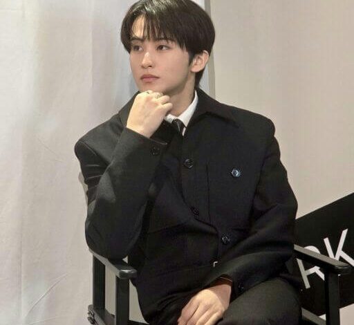 people-1-male-A-black suit-B-seated-C-looking away