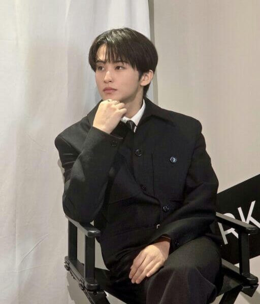 people-1-male-A-black suit-B-seated-C-looking away