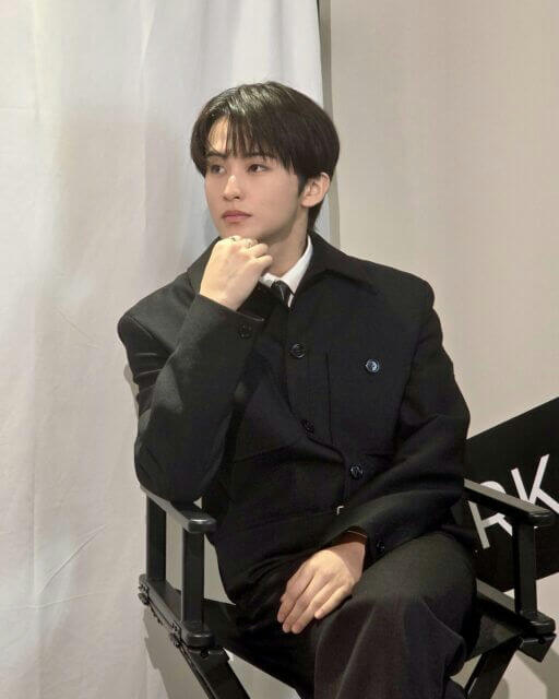people-1-male-A-black suit-B-seated-C-looking away