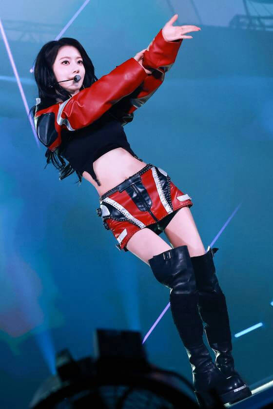 people-female performer-A-stage performance-A-black hair-A-red and black outfit-A-thigh-high boots