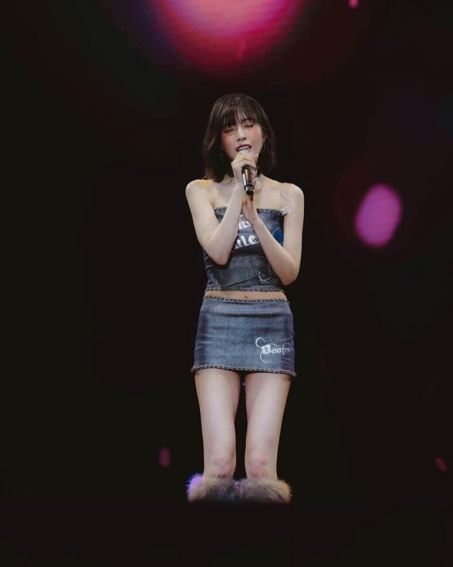 people-A-female singer-A-performing on stage-B-denim tube top and mini skirt-C-fur trim ankle accessories
