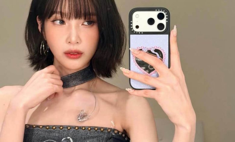 people-woman-A-bob haircut-A-dark denim strapless top-A-choker necklace-A-selfie