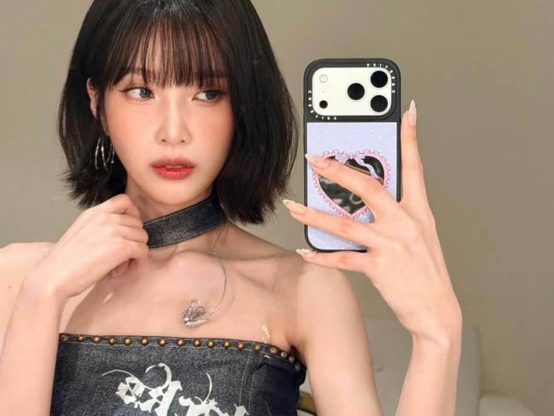people-woman-A-bob haircut-A-dark denim strapless top-A-choker necklace-A-selfie