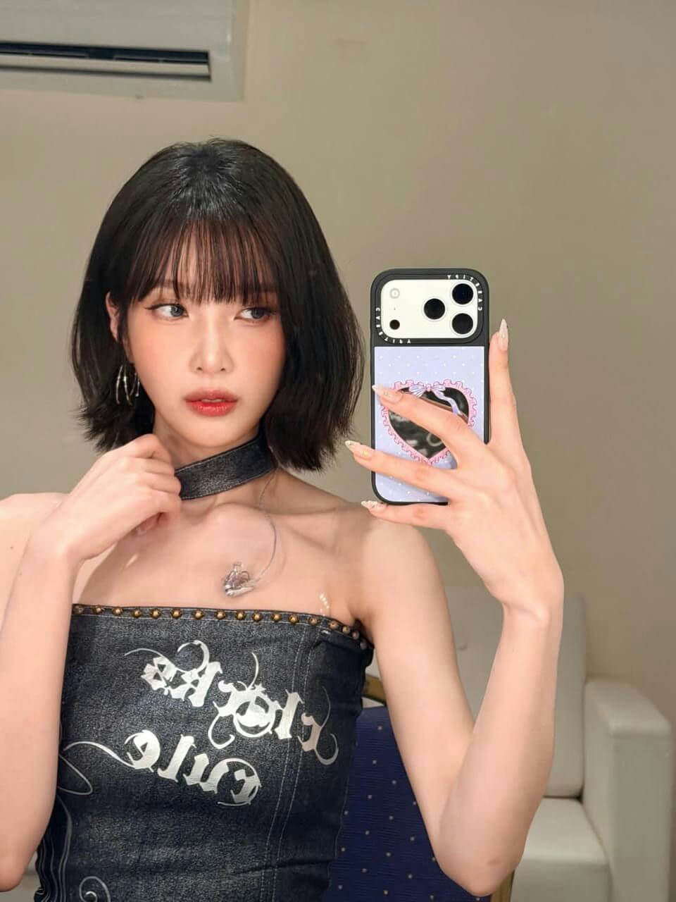 people-woman-A-bob haircut-A-dark denim strapless top-A-choker necklace-A-selfie