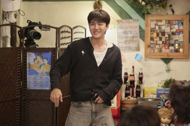 people-Sehun (EXO)-smiling-A-black cardigan-A-white undershirt-B-denim jeans-C-indoor setting-C