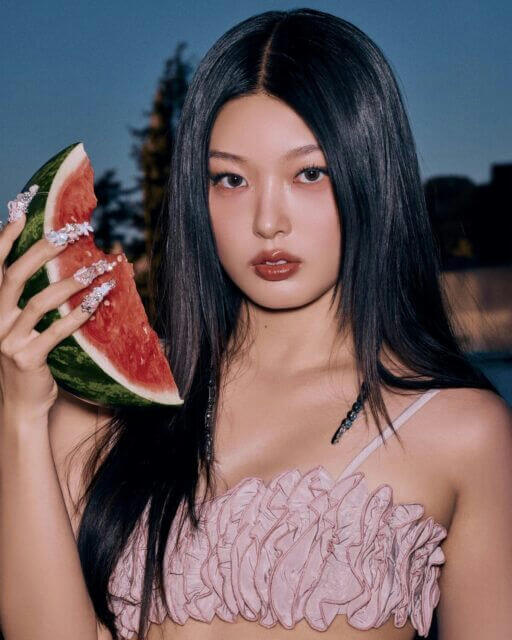 people-woman-watermelon-A-long black hair-A-pink ruffled top-A-long decorated nails