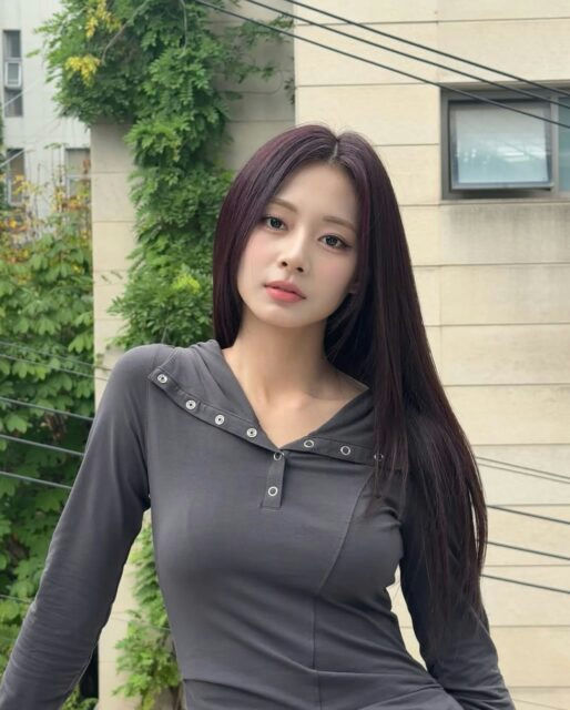 people-woman-A-long dark hair-B-grey long-sleeved top-C-outdoor setting