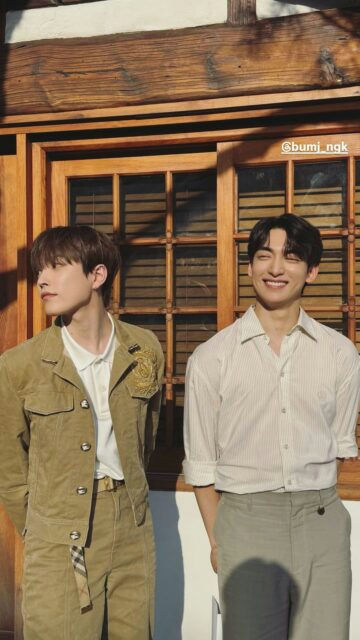 people-Two young men-A-standing outdoors-B-smiling brightly-C-wearing stylish light-colored clothing