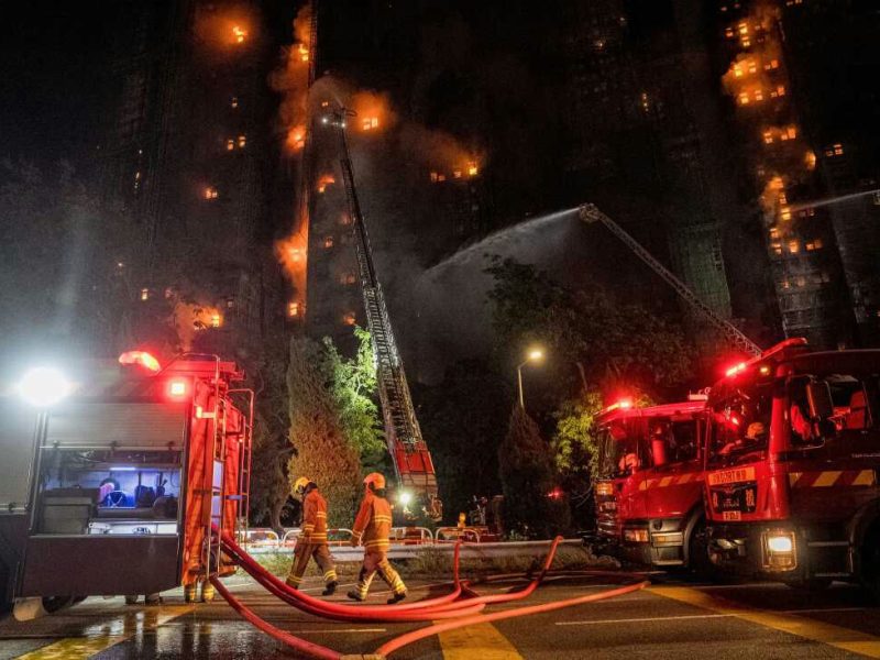 Nighttime fire-A-high-rise-A-firefighters-A-fire-trucks-A-ladder-truck-A-hoses