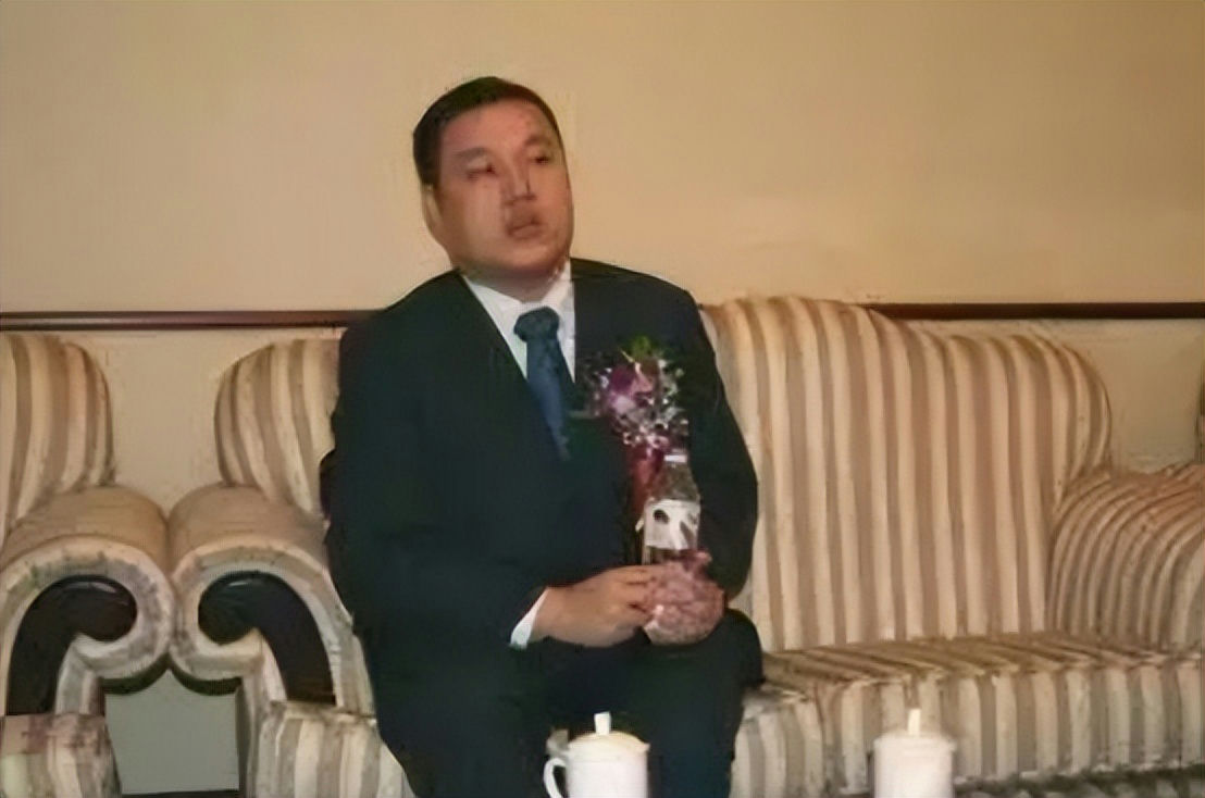 people-1-man-A-suit-B-holding bottle-C-sitting on striped couch