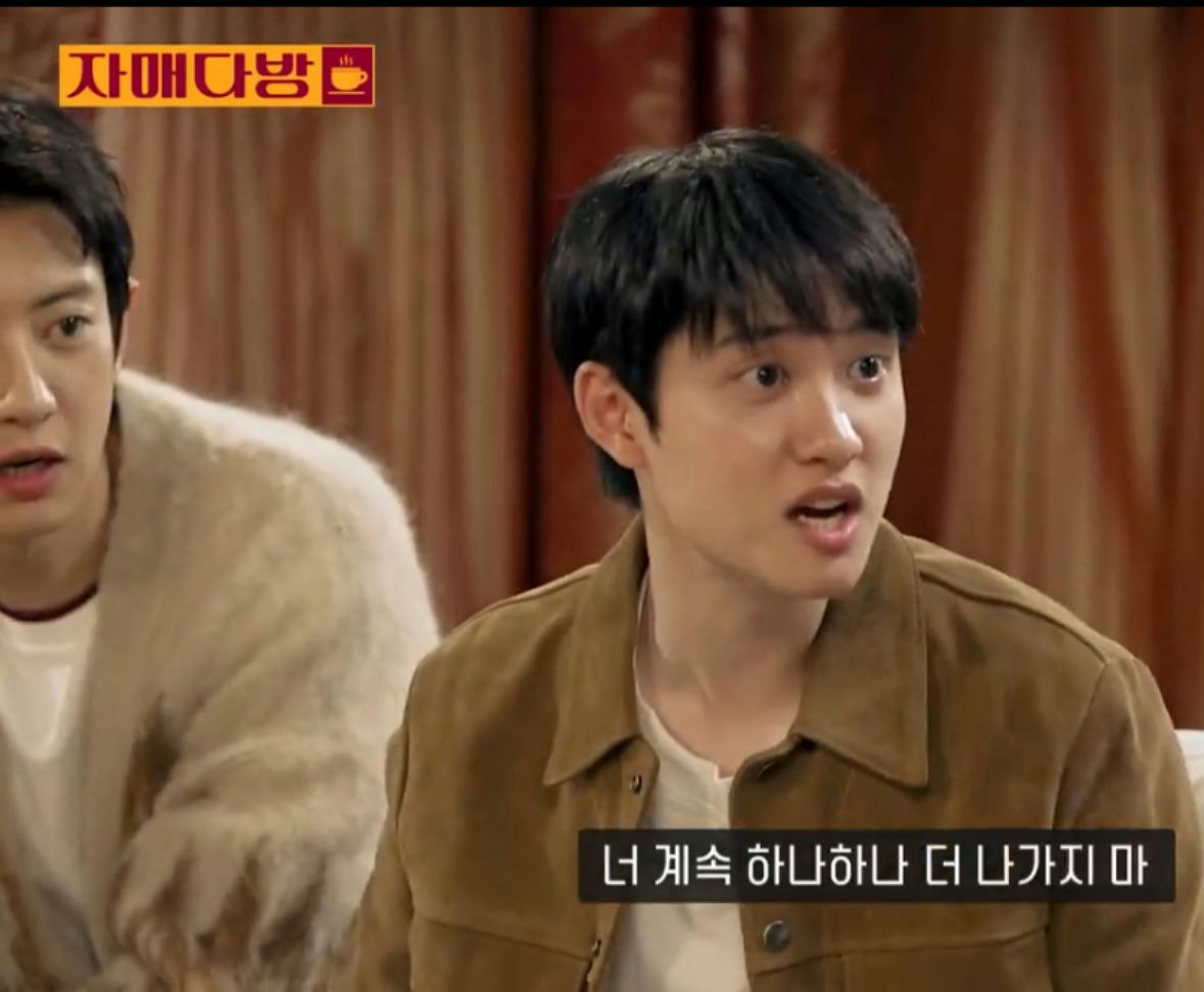 people-Two young men-A-indoor setting-A-Korean subtitles-B-Man in foreground wearing brown jacket-C-Man in background wearing white fuzzy jacket