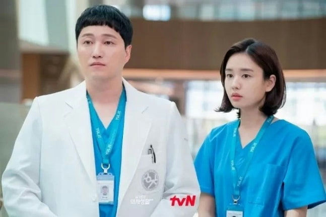 people-two medical professionals-A-male doctor-A-female surgeon-B-white lab coat-C-blue scrubs