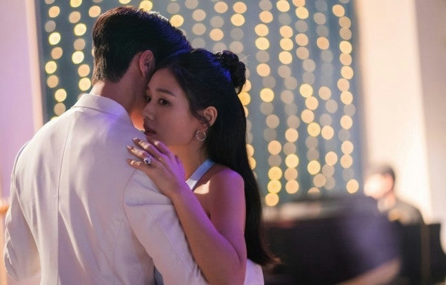 people-woman-and-man-dancing-or-embracing-woman-wearing-ring-on-finger-background-bokeh-lights
