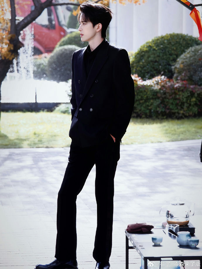 people-man-A-black suit-B-outdoor setting-C-tea set